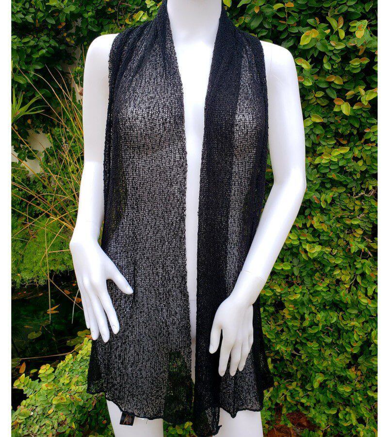 A mannequin wearing a black vest and white dress.