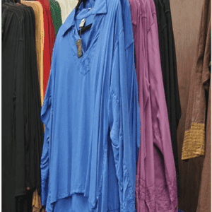 Loose blue shirt hanging on clothing rack